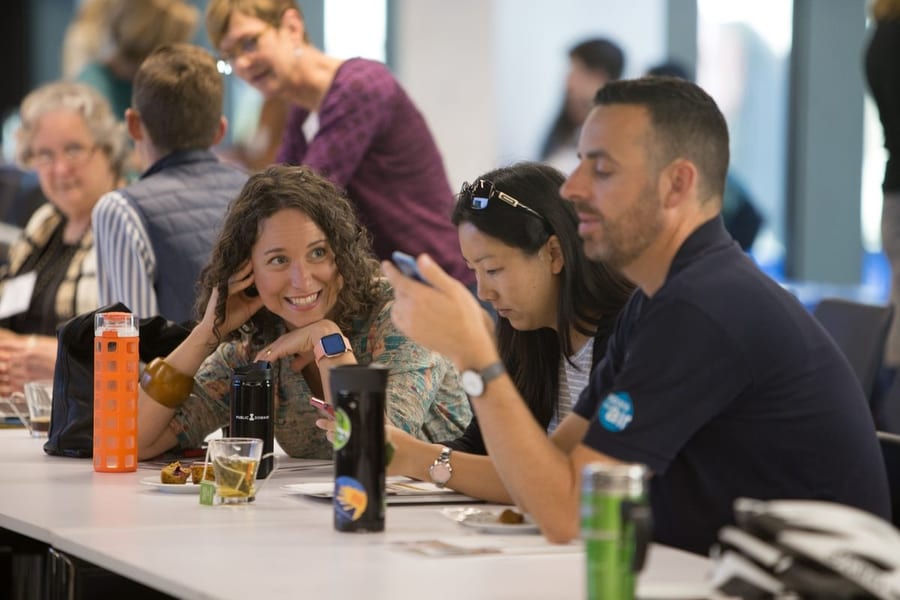 Attendees collaborating around a breakout table during a workshop at LinkedIn headquarters, San Francisco — corporate event photography by Michael Pegram