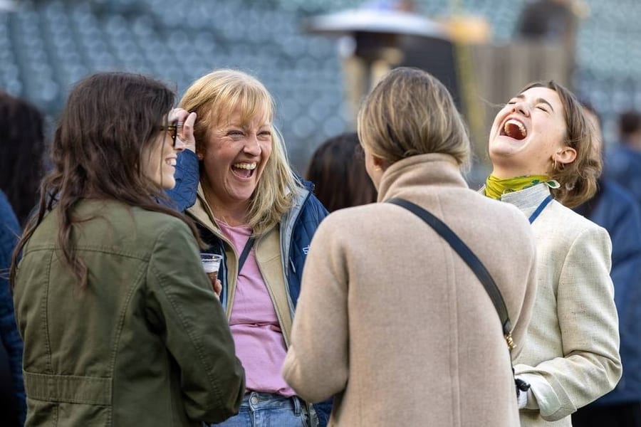 Guests sharing a laugh at Farallon Takes the Field at Oracle Park — corporate event photography by Michael Pegram