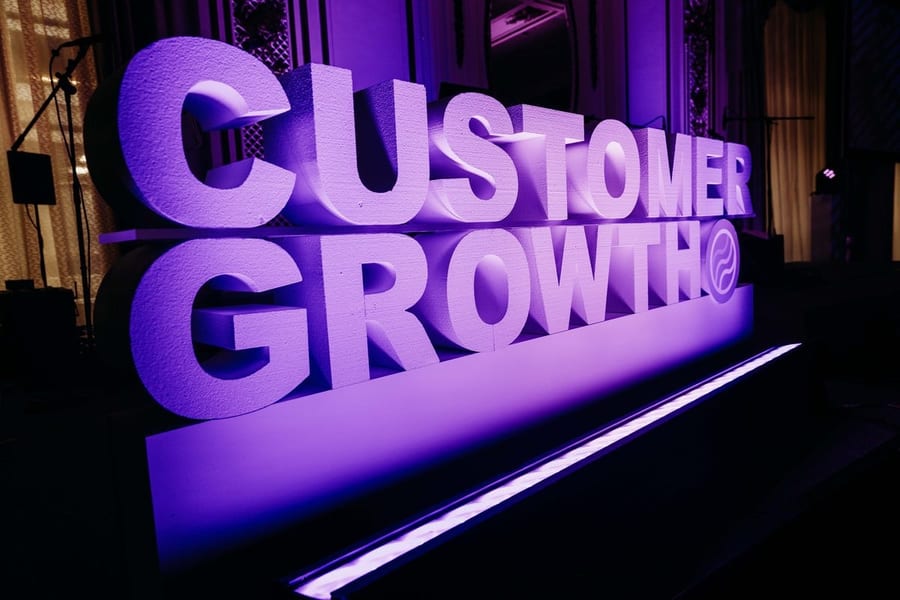 Glowing purple Customer Growth sign at the Customer Growth Awards in San Francisco — corporate event photography by Michael Pegram