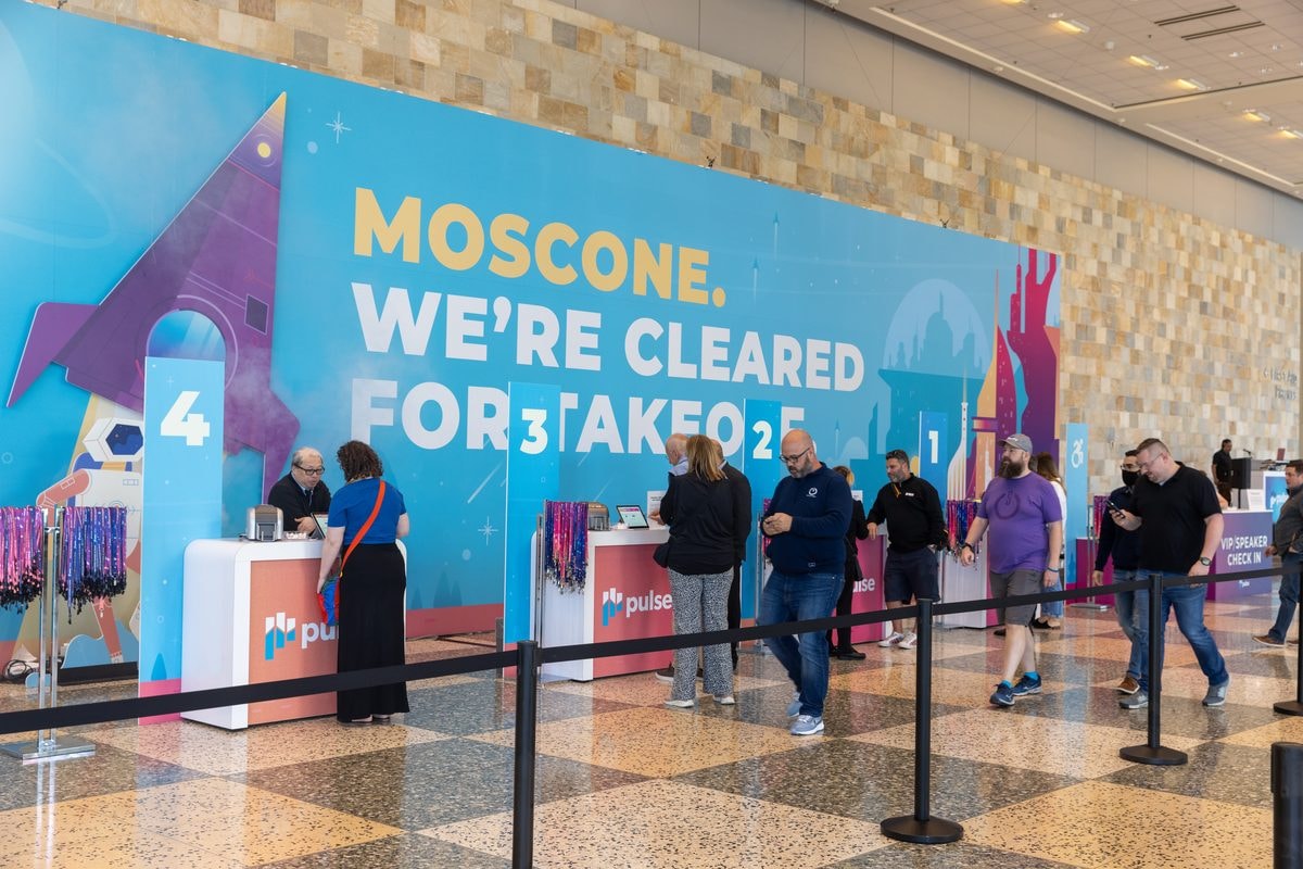Gainsight Pulse registration under the Moscone, We're Cleared for Takeoff wall at Moscone West, San Francisco — corporate event photography by Michael Pegram