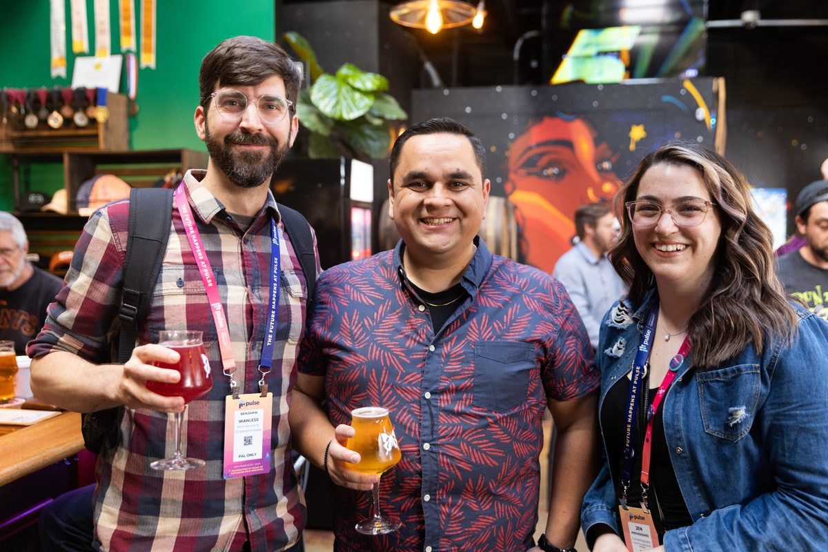 Attendees raising drinks at the Gainsight Pulse happy hour in San Francisco — corporate event photography by Michael Pegram