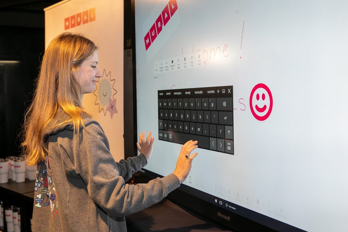 Attendee using an interactive touch-screen booth at ProductCon San Francisco — corporate event photography by Michael Pegram