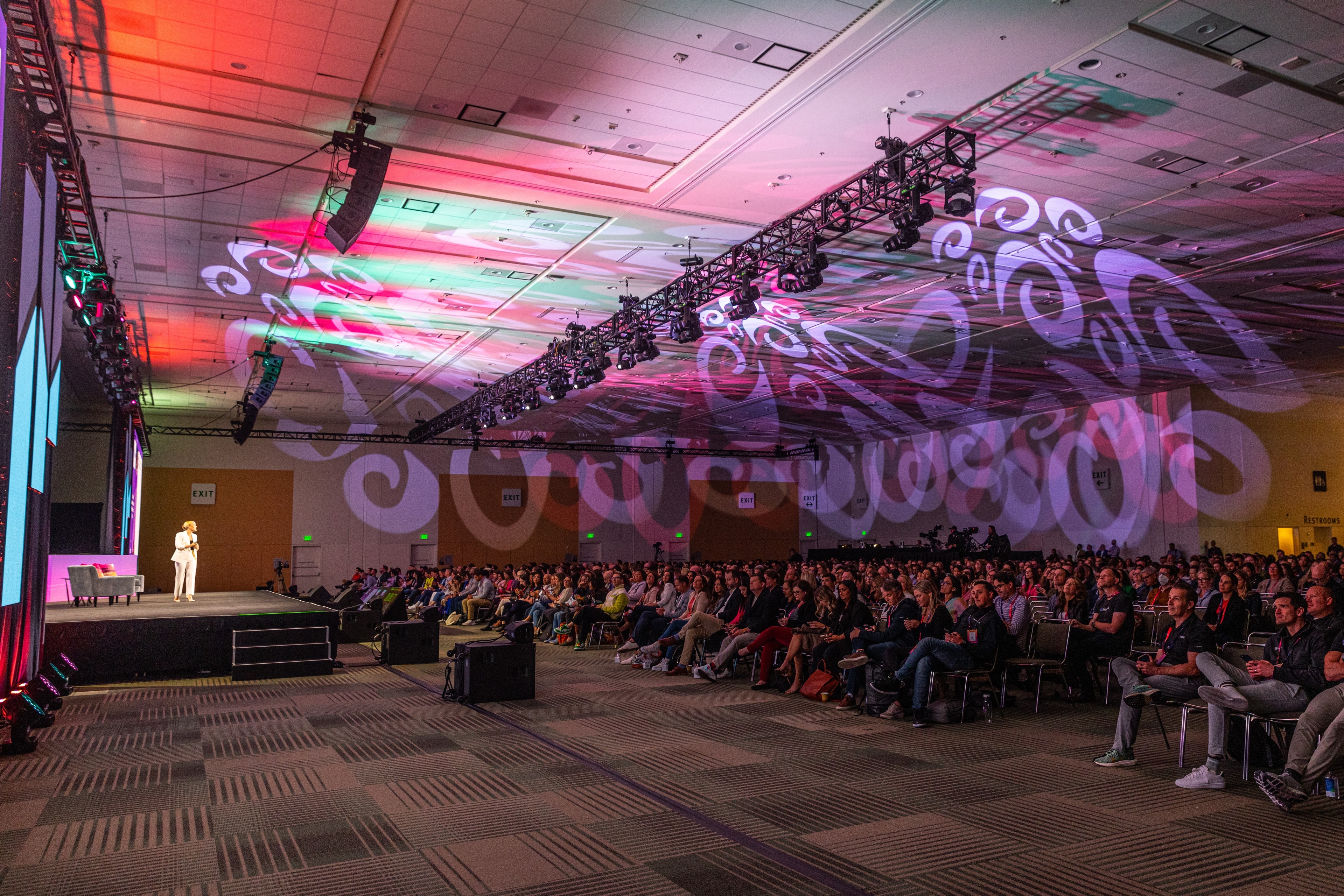 Large conference ballroom with neon lighting and packed audience — Bay Area event photography by Michael Pegram