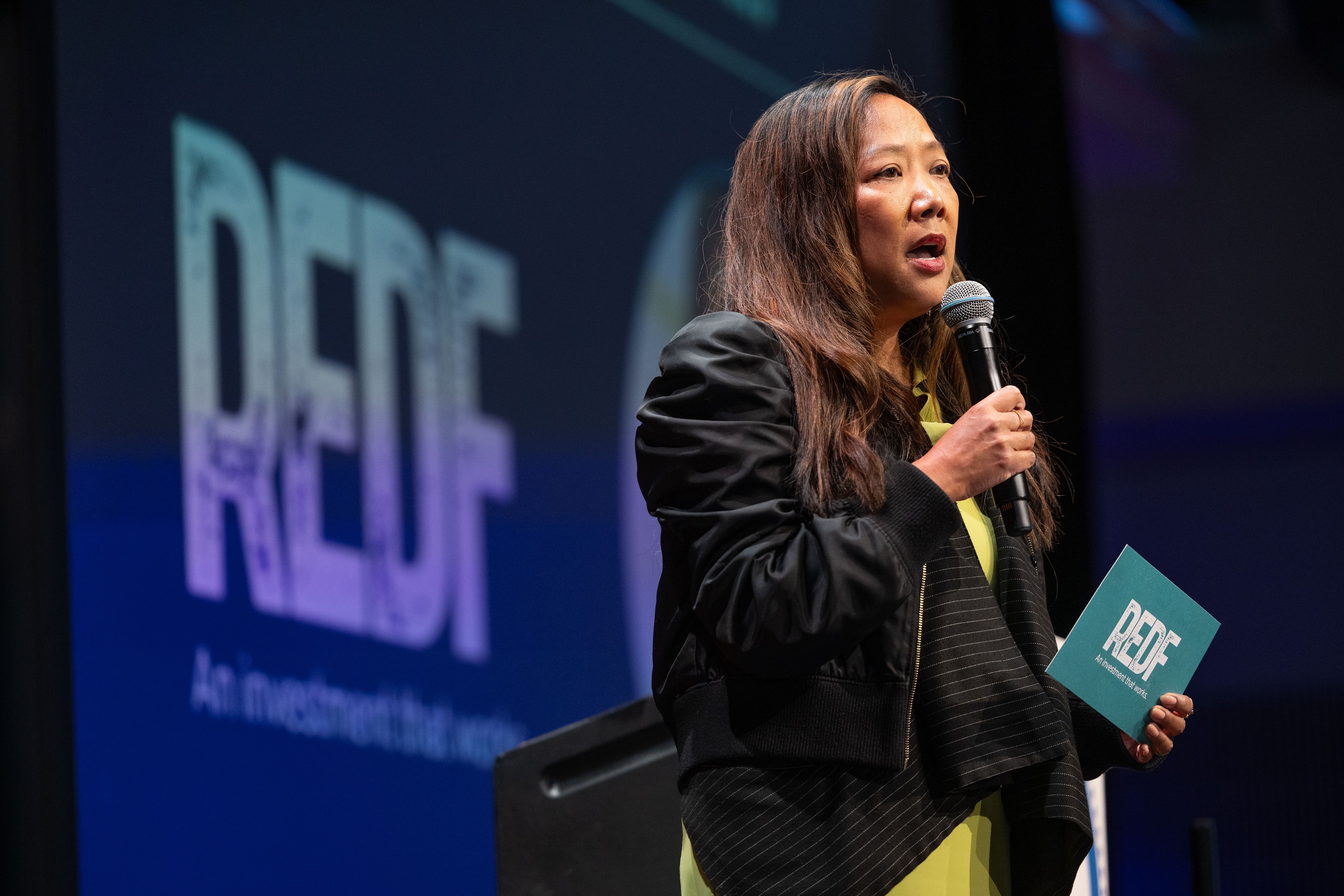 Woman speaking at REDF conference with microphone — Michael Pegram Photography
