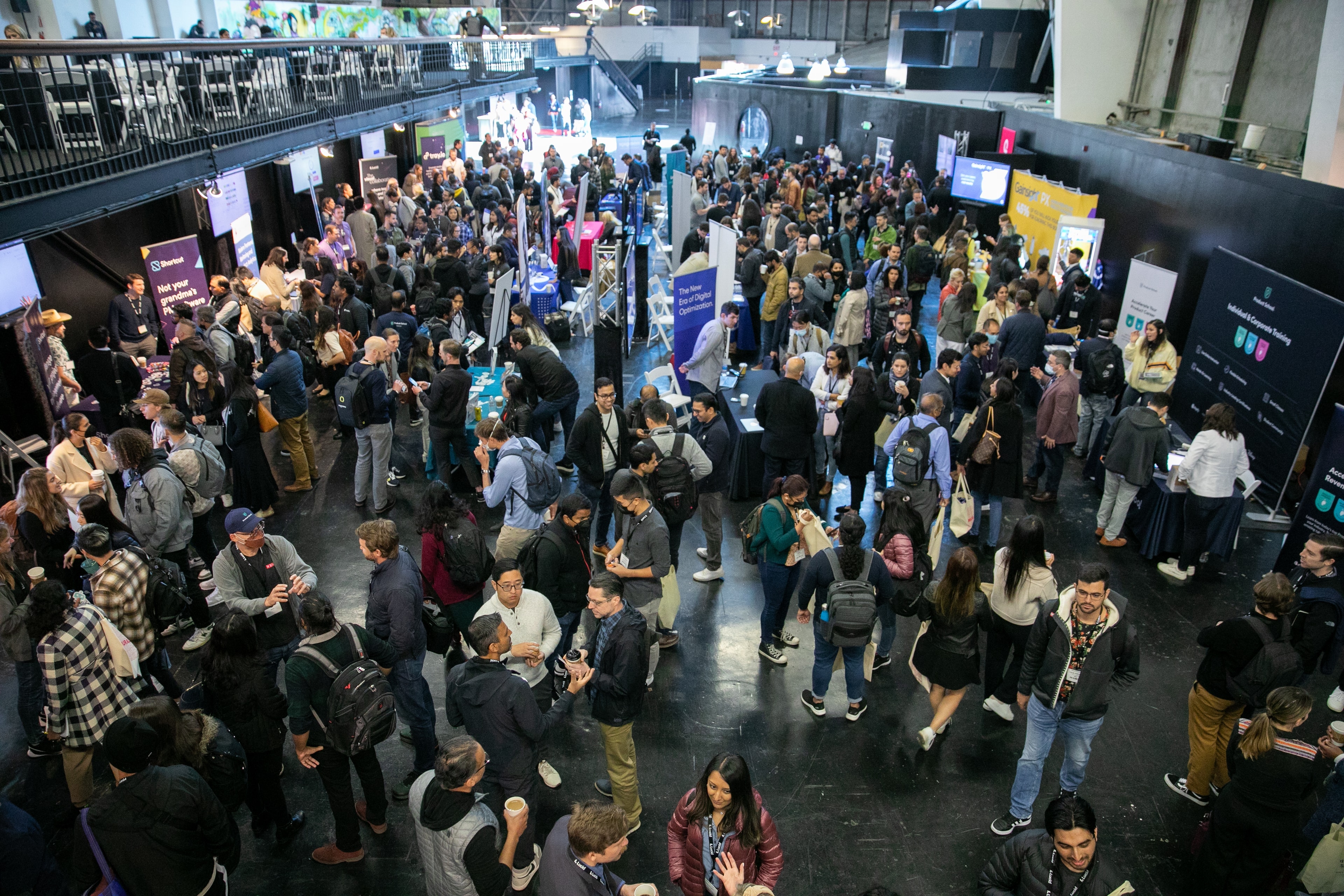 Crowded tech conference expo floor overhead view — Michael Pegram Photography