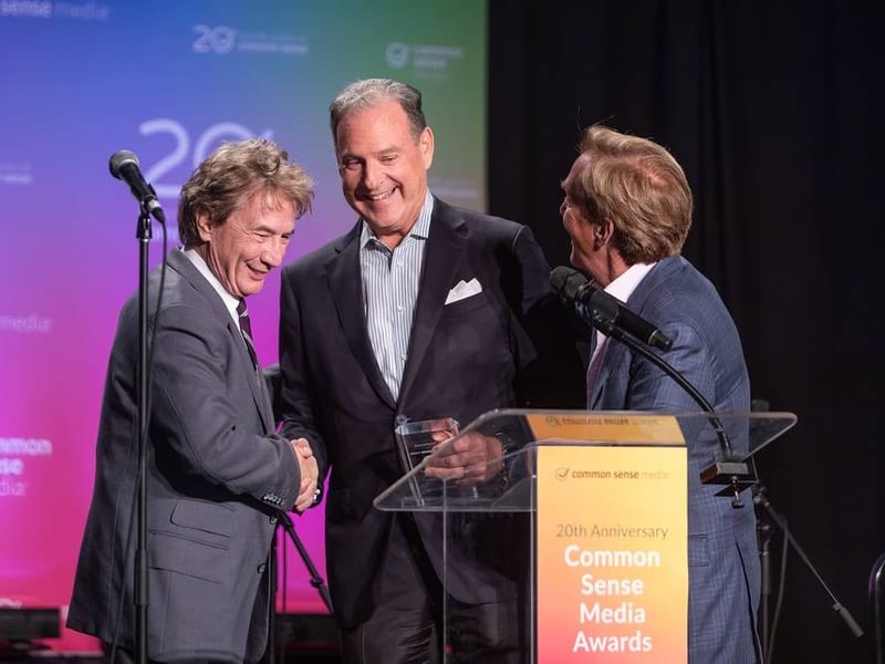 Presenters greeting each other on stage at the Common Sense Media awards in San Francisco — event photography by Michael Pegram