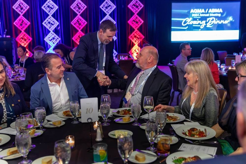 Guests greeting each other at an association annual meeting closing dinner — corporate event photography by Michael Pegram