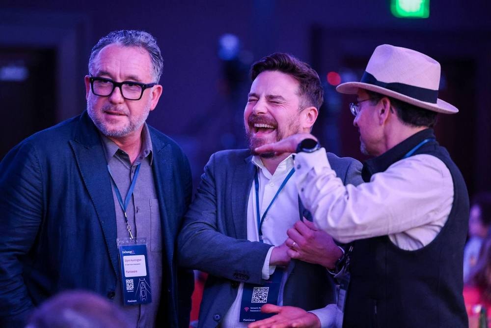 Attendees laughing together at the Planisware awards dinner — corporate event photography by Michael Pegram