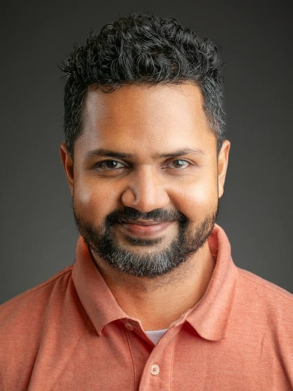 Corporate headshot of a man with a beard wearing a coral polo shirt — Bay Area headshot by Michael Pegram