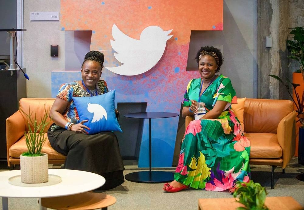 Women in Tech event attendees seated beneath the Twitter logo in San Francisco — event photography by Michael Pegram