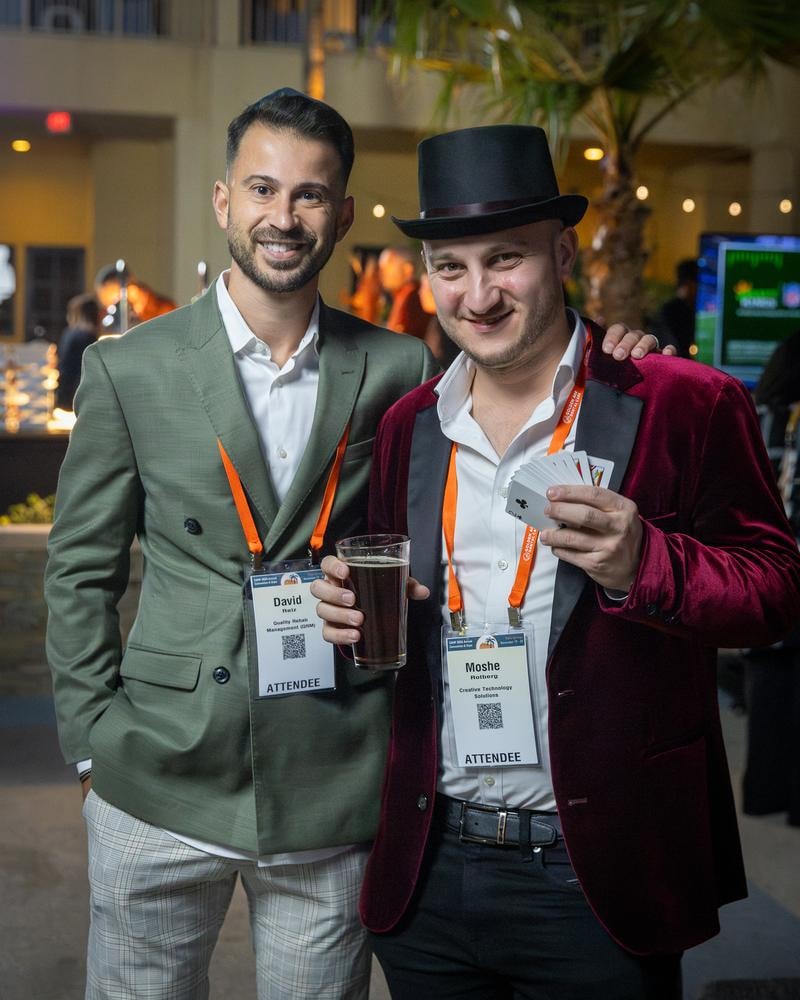 Magician entertaining guests at a conference evening reception — event photography by Michael Pegram