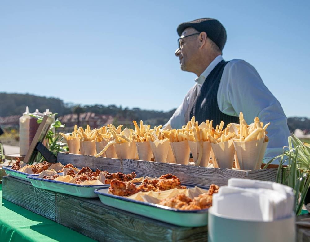 Chef at a French fries catering station during an outdoor corporate event — event photography by Michael Pegram
