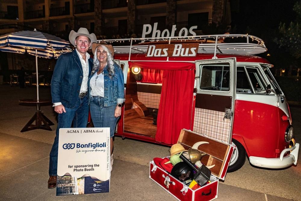 Guests posing at a vintage Photo Bus booth at an association dinner — event photography by Michael Pegram