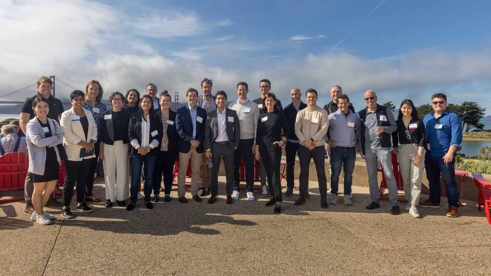 Conference attendees group photo with a San Francisco Bay view — event photography by Michael Pegram