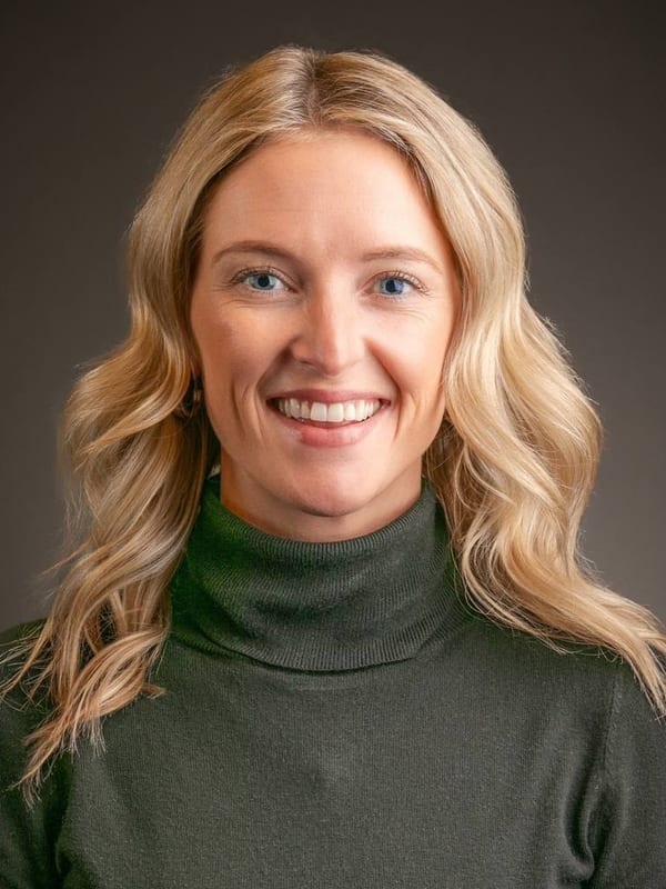Corporate headshot of a woman with blonde wavy hair smiling — San Francisco headshot by Michael Pegram