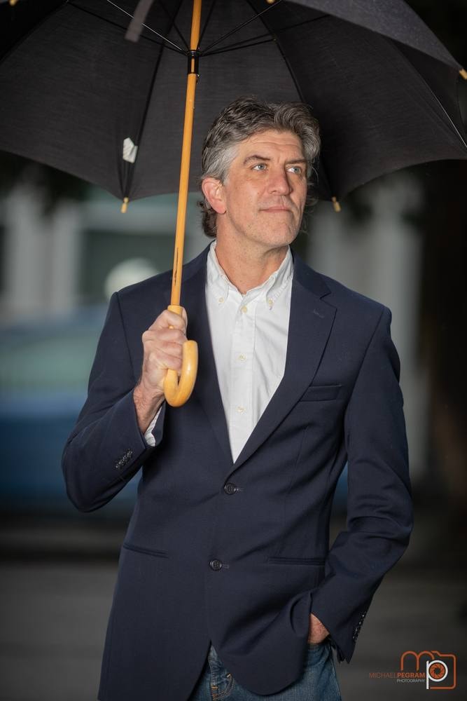 Executive portrait of a businessman holding a black umbrella — Bay Area portrait by Michael Pegram